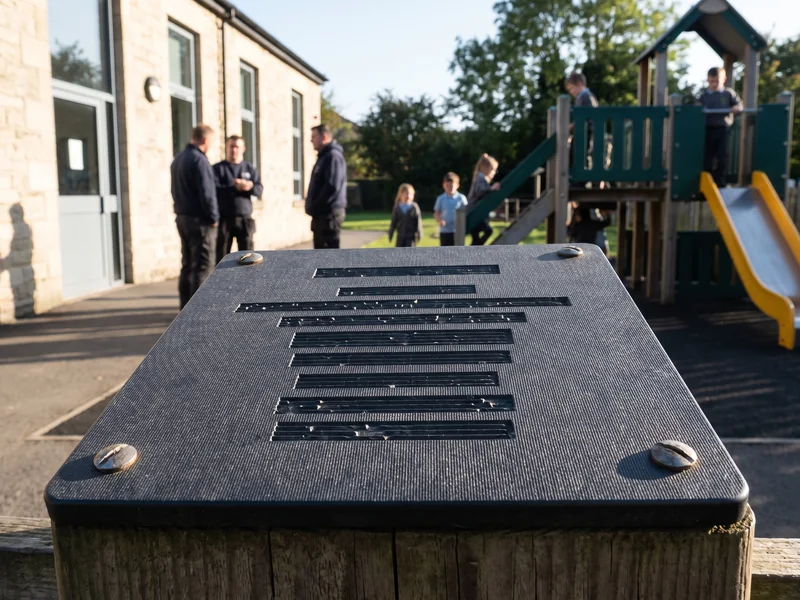 Close-up of an engraved HDPE plaque in raking light