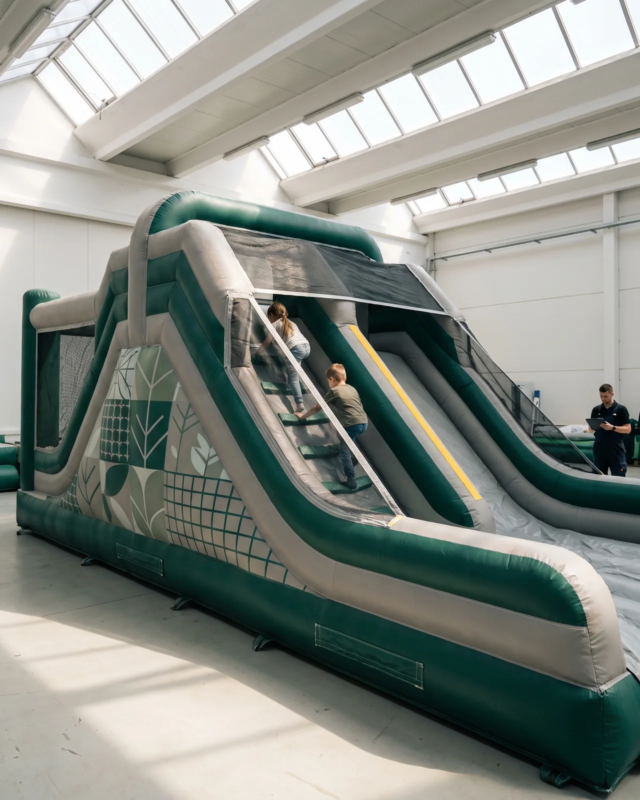 Combo inflatable with netted walls, inner climbing steps and a side slide in a skylit venue