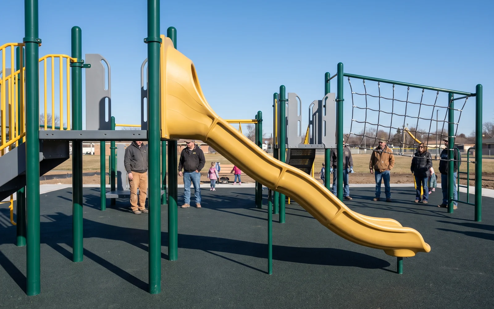 Installed play structure with steel posts, a rotomolded slide and a climbing net