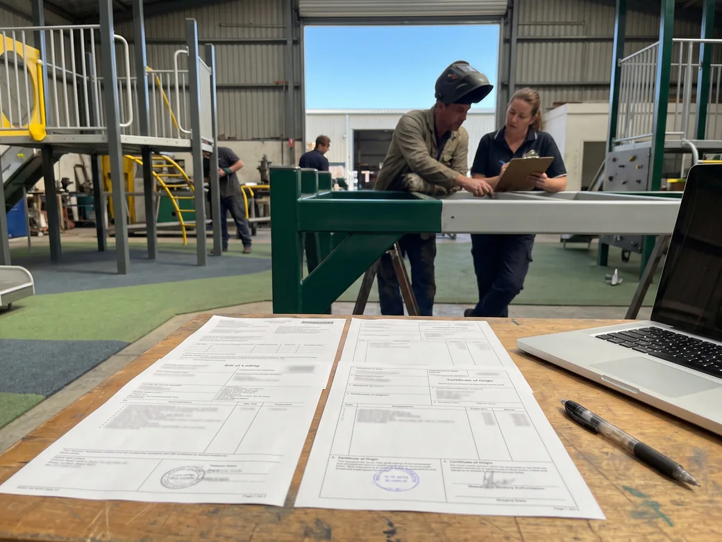 A bill of lading, commercial invoice, packing list and certificate of origin on a desk