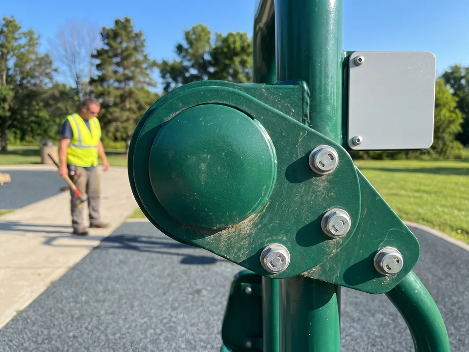 The pivot cover and tamper-resistant bolts on a chest press lever arm