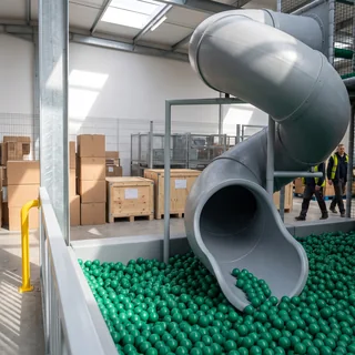 The exit of a rotomolded tube slide into a ball pit