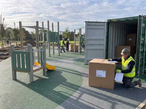 An installer checking a numbered carton against the packing list