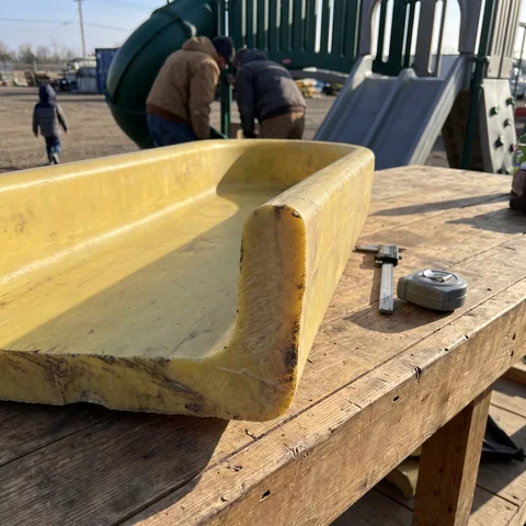 The cut edge of a rotomolded plastic slide wall