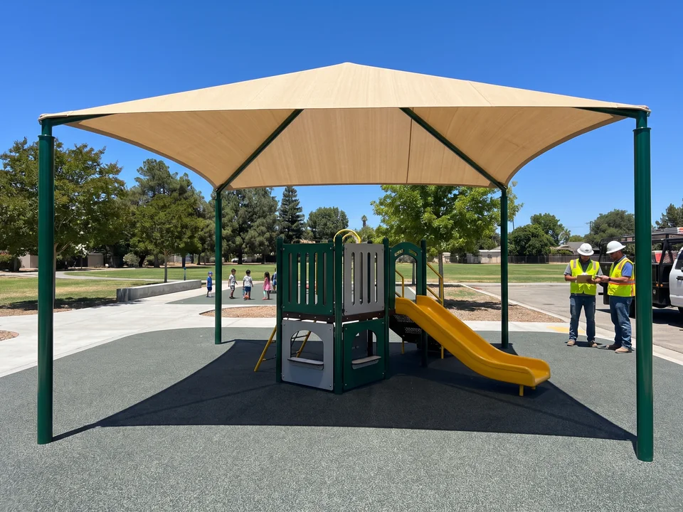 Hip canopy on a steel frame over a compact square play structure