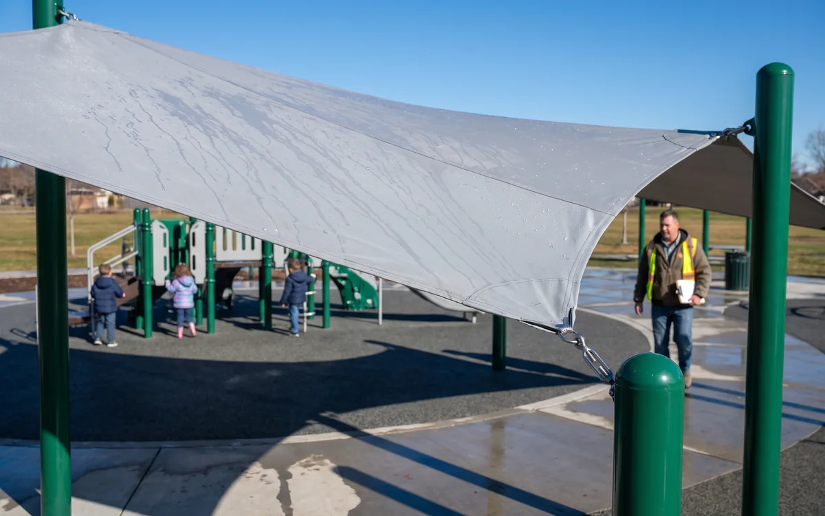 PVC-coated polyester canopy with rain beads running to the edge