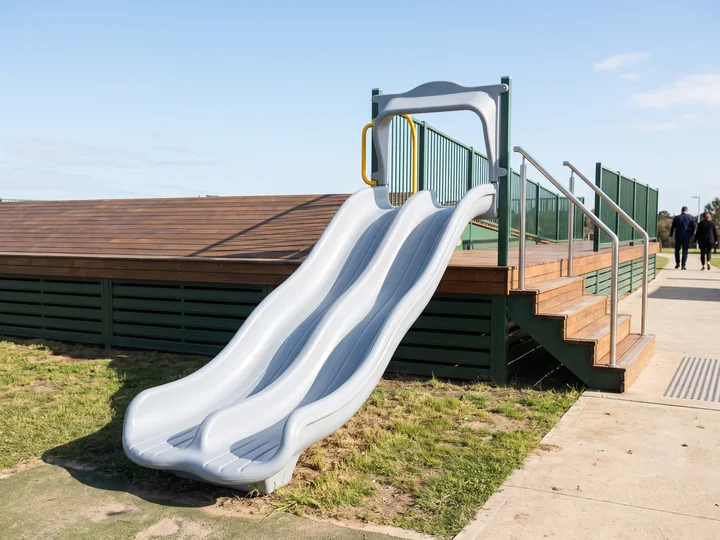 A double-lane wave slide leaving a wide deck opening