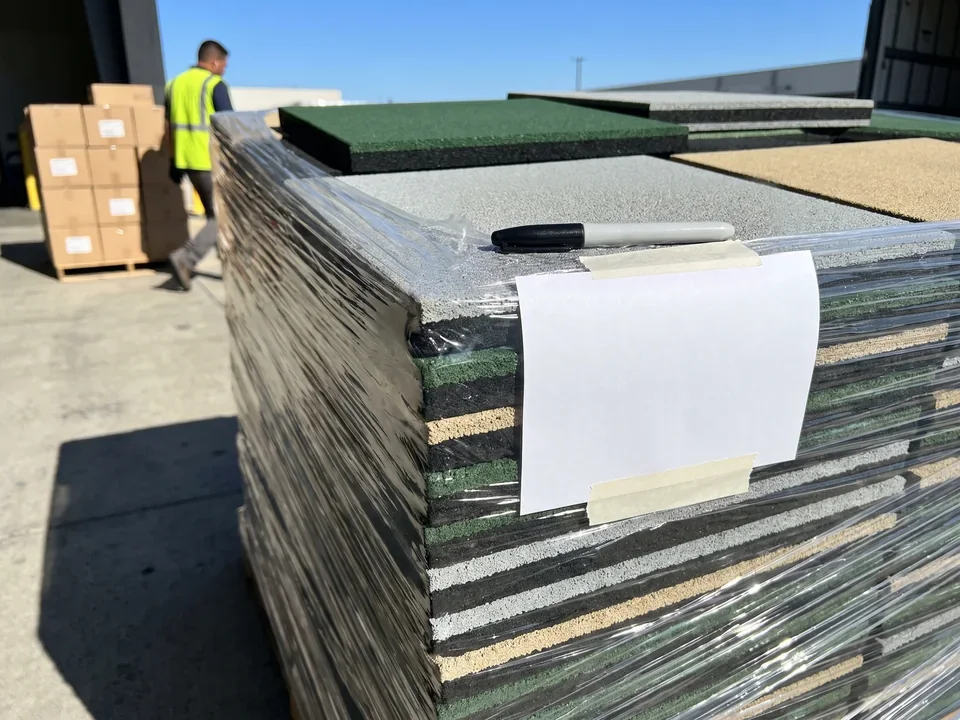 Blank white zone label on the corner of a pallet of rubber tiles