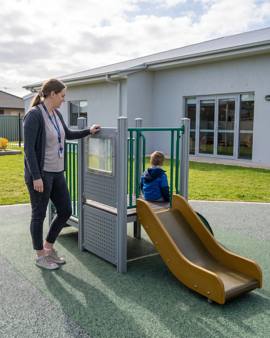 A teacher standing on the ground reaches the top deck of a low-deck structure