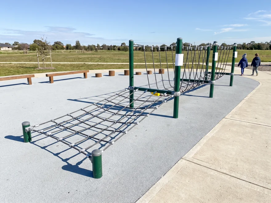 A low climbing net and low rope walk surrounded by surfacing in a 2 to 5 zone