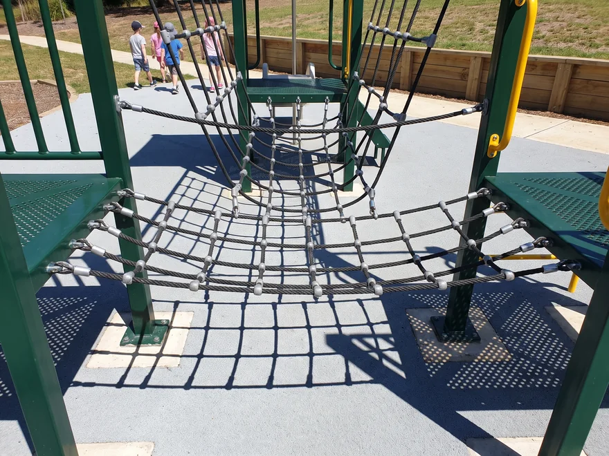 A rope bridge spanning two decks with net sides