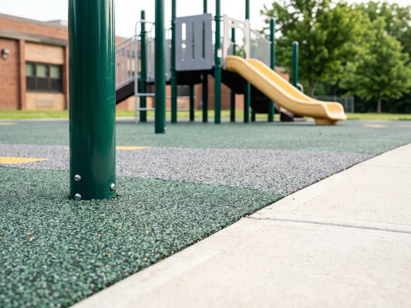 Poured EPDM rubber surfacing meeting a concrete path