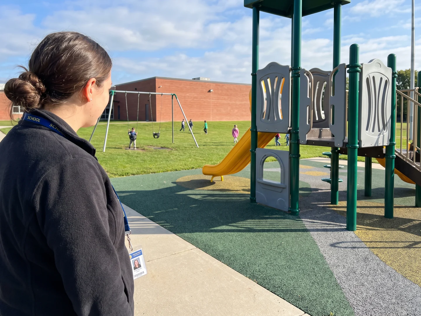 Teacher on duty at the edge of the playground with a clear view across the play zones
