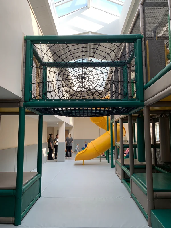 Spider net climbed between two levels of a soft play structure