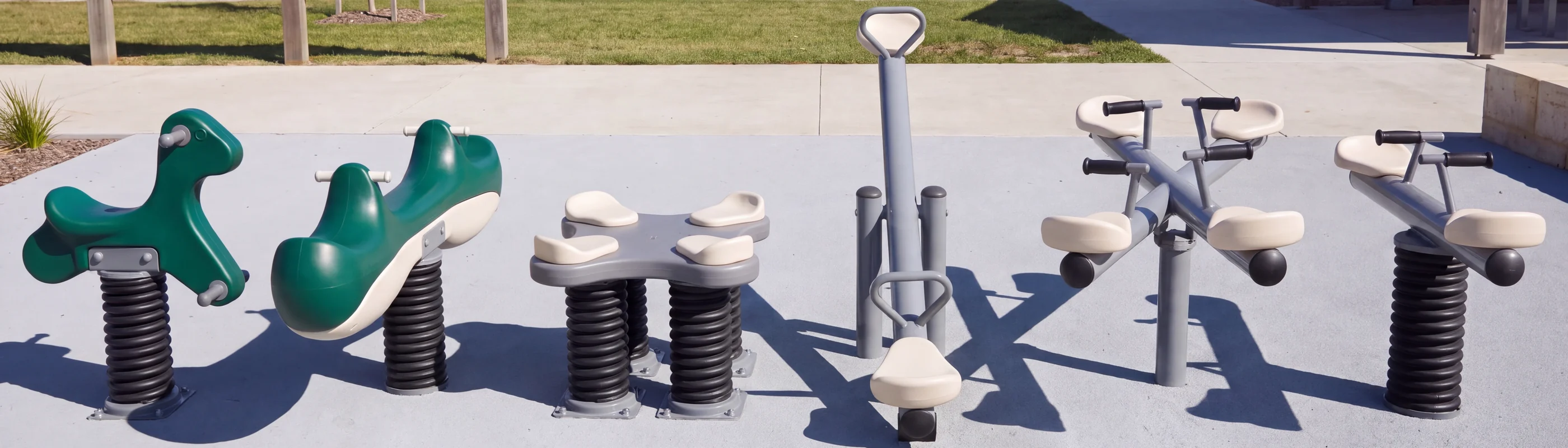 Six rockers in a row: single-seat, two-seat and four-seat spring riders, a classic seesaw, a four-seat seesaw and a spring seesaw
