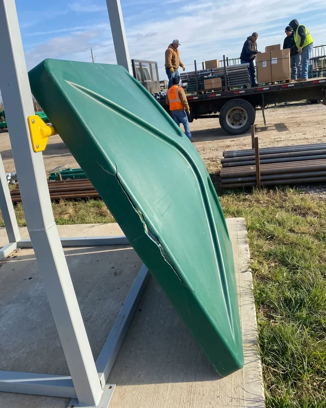 A cracked evergreen HDPE roof panel on a playground, photographed by phone